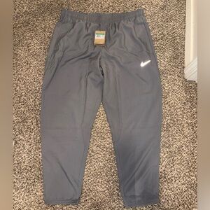 Nike Dri-fit joggers in grey w/ reflective logo. New. XL men’s